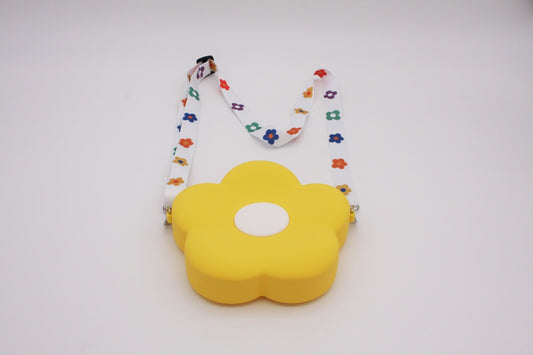 Bright yellow daisy shaped childrens' bag with colourful daisies on the white strap