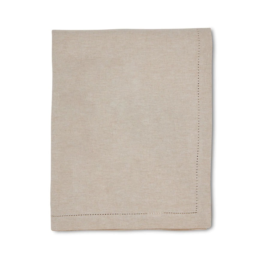 Folded cream coloured tablecloth