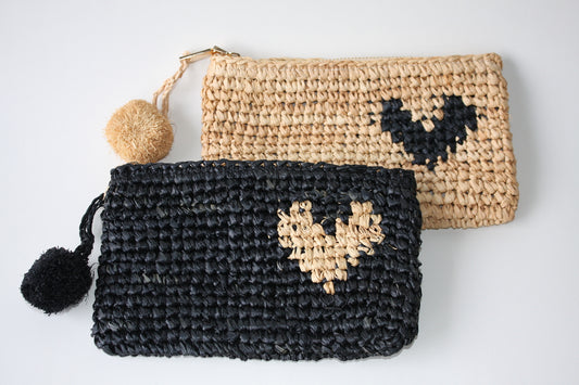 Black woven clutch with straw coloured love heart and straw coloured clutch with black love heart