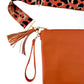Orange leather bag with orange tassel and leopard print bag strap
