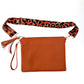 Orange bag with leopard print bag strap
